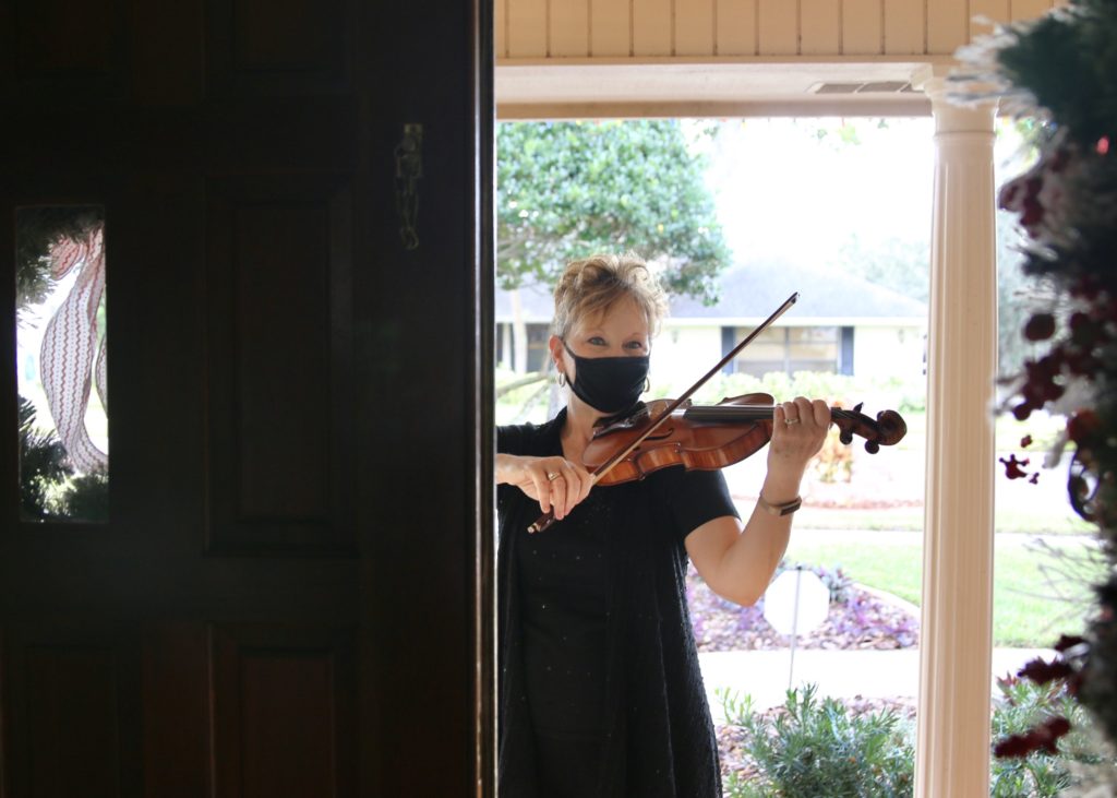 Violinist performing at door